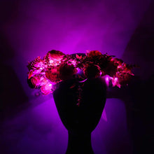 Fairy festival flower crown with roses, wildflowers, and glowing hot pink lights for boho style 