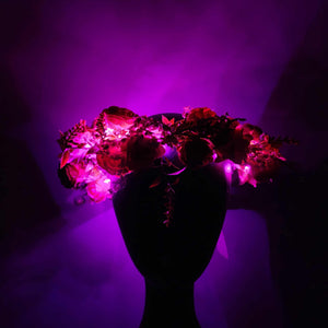 Fairy festival flower crown with roses, wildflowers, and glowing hot pink lights for boho style 