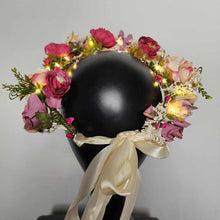 Midsummer night flower crown with blush pink roses, lavender flowers, greenery, and LED lights on black mannequin head
